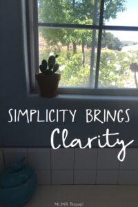 Plant growning in a sunny window with text - Simplicity Brings Clarity